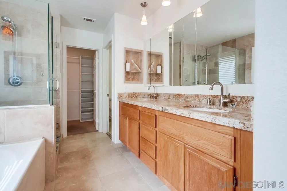 3924 Tortuga Cove Oceanside, CA 92058 - Photo 20 of 42 a bathroom with a granite countertop sink mirror and double