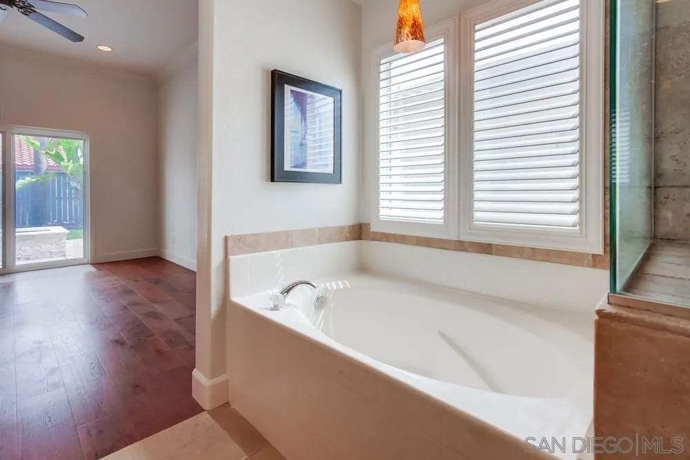 3924 Tortuga Cove Oceanside, CA 92058 - Photo 22 of 42 a bathroom with a bathtub and a sink