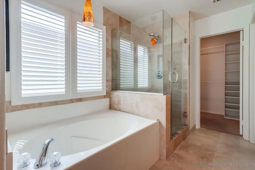 3924 Tortuga Cove Oceanside, CA 92058 - Photo 23 of 42 a spacious bathroom with bathtub and shower