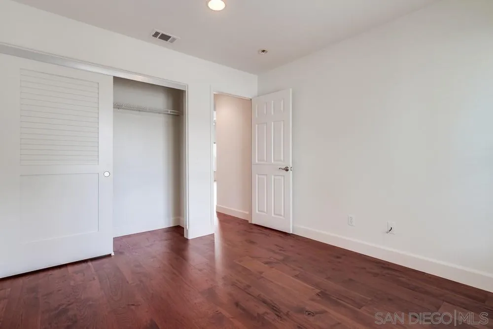 3924 Tortuga Cove Oceanside, CA 92058 - Photo 28 of 42 a view of an empty room with wooden floor