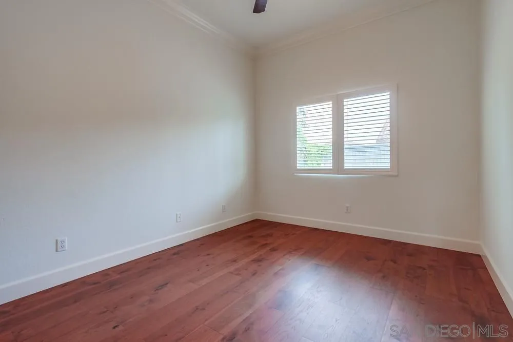 3924 Tortuga Cove Oceanside, CA 92058 - Photo 29 of 42 an empty room with wooden floor and windows