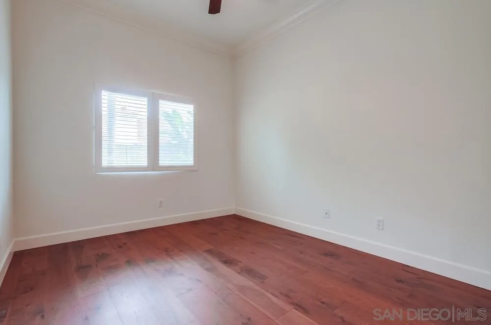 3924 Tortuga Cove Oceanside, CA 92058 - Photo 30 of 42 an empty room with wooden floor and windows