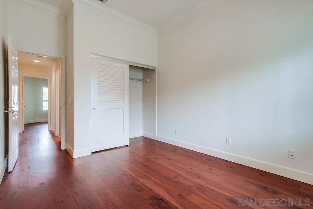 3924 Tortuga Cove Oceanside, CA 92058 - Photo 31 of 42 a view of a hallway with wooden floor
