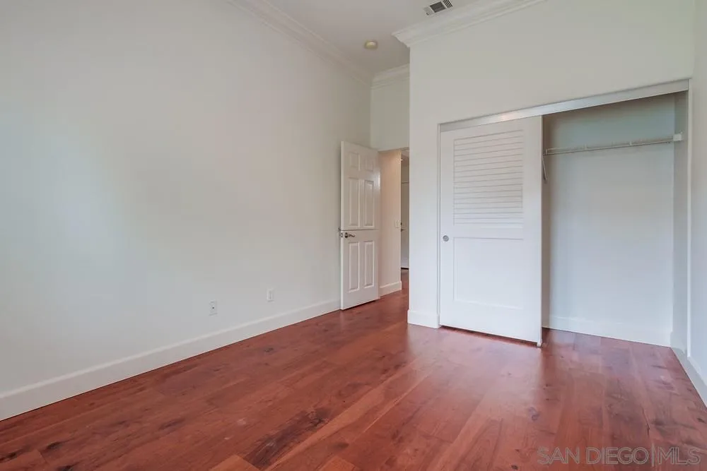 3924 Tortuga Cove Oceanside, CA 92058 - Photo 32 of 42 a view of an empty room with wooden floor