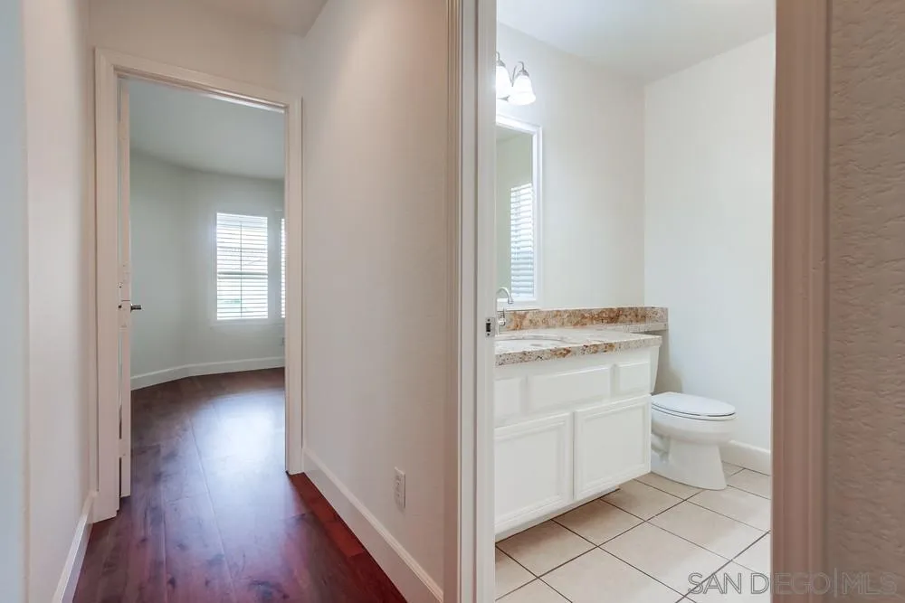 3924 Tortuga Cove Oceanside, CA 92058 - Photo 33 of 42 a bathroom with a toilet sink and a mirror