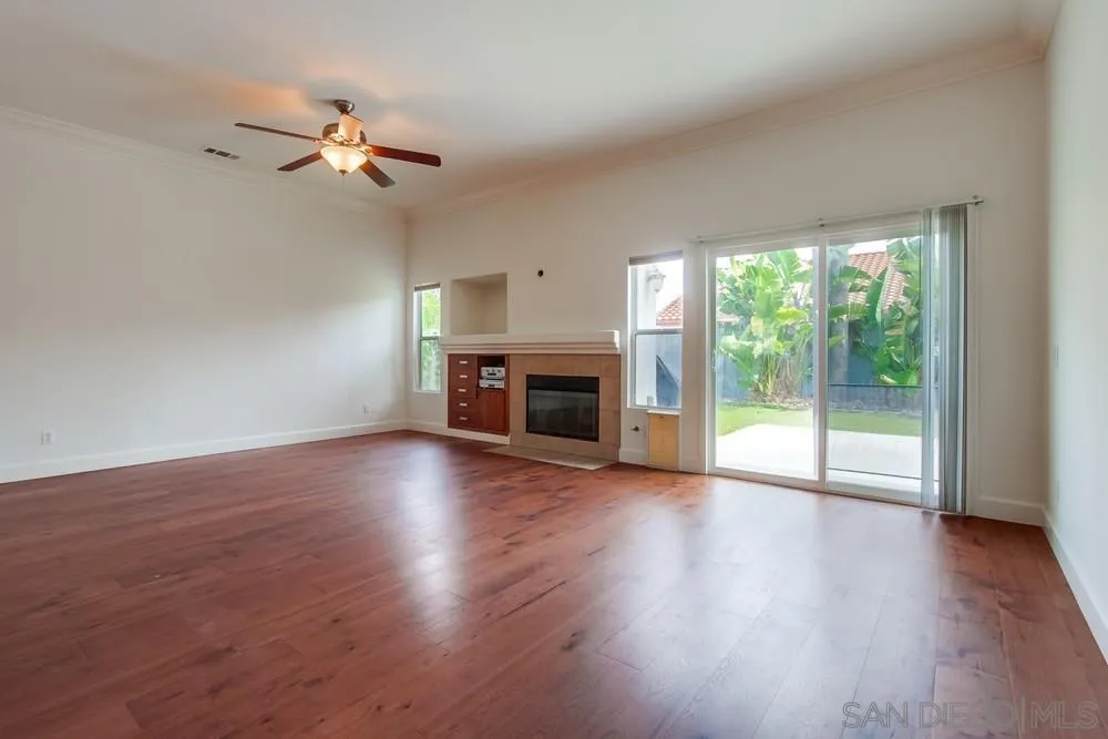 3924 Tortuga Cove Oceanside, CA 92058 - Photo 4 of 42 a view of empty room with wooden floor and fireplace