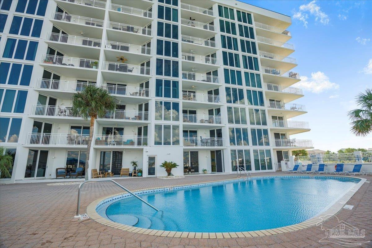 16284 Perdido Key Drive, Unit 112 Perdido Key, FL 32507 - Photo 14 of 37 a view of a swimming pool and a buildings
