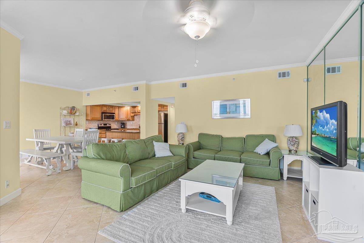 16284 Perdido Key Drive, Unit 112 Perdido Key, FL 32507 - Photo 15 of 37 a living room with furniture a flat screen tv and kitchen view
