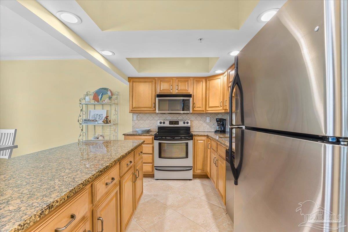16284 Perdido Key Drive, Unit 112 Perdido Key, FL 32507 - Photo 21 of 37 a kitchen with a refrigerator a stove top oven a sink and dishwasher