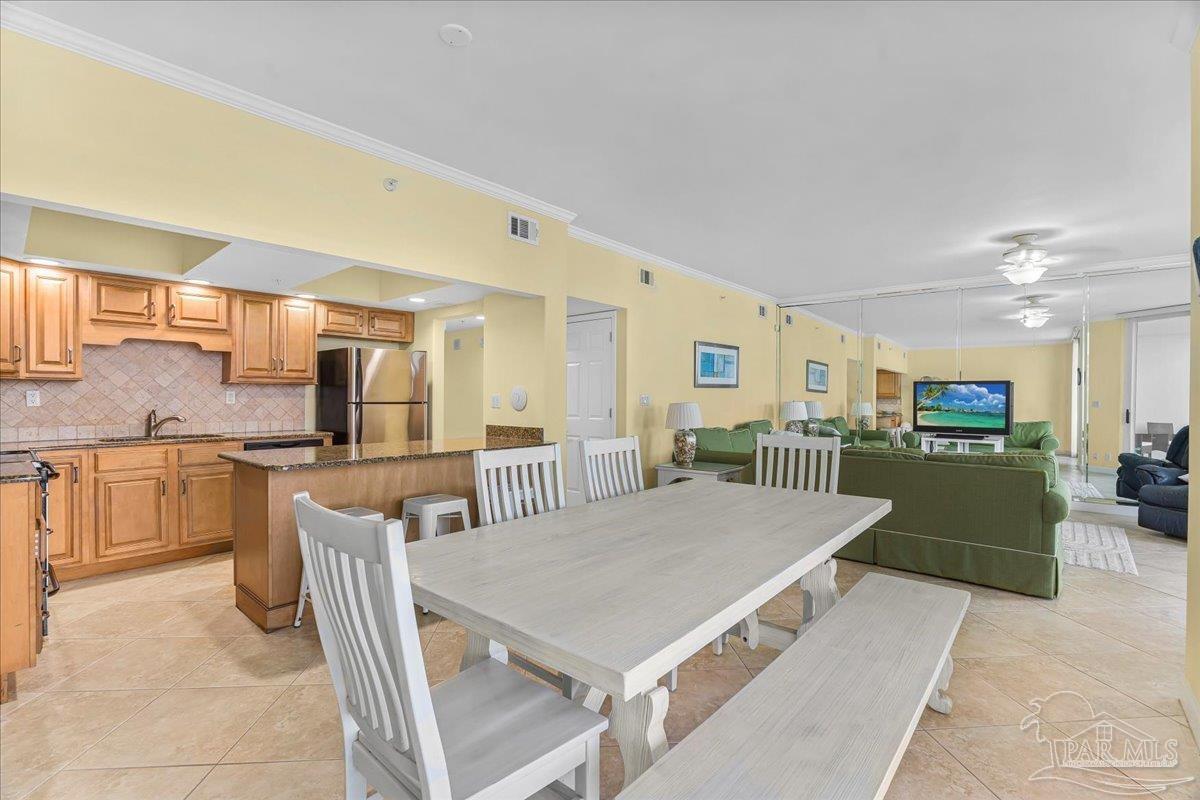 16284 Perdido Key Drive, Unit 112 Perdido Key, FL 32507 - Photo 23 of 37 a large kitchen with a table and chairs