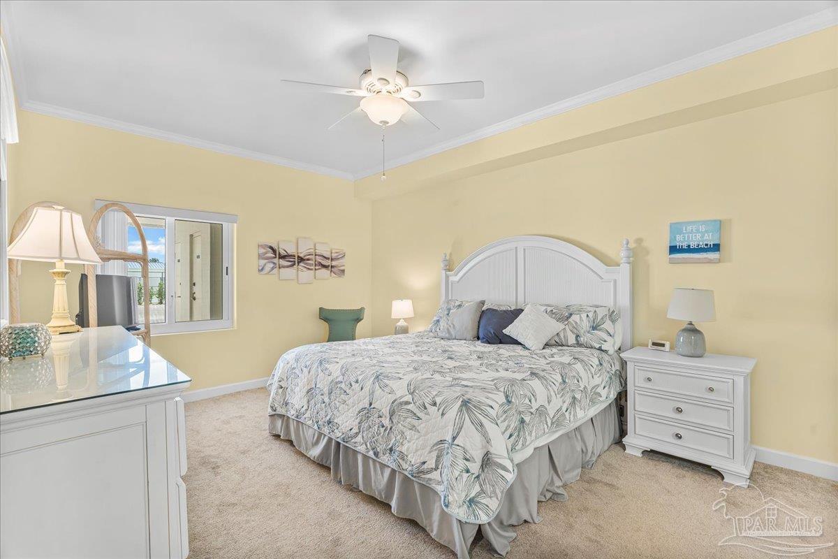 16284 Perdido Key Drive, Unit 112 Perdido Key, FL 32507 - Photo 25 of 37 a bedroom with a bed and a chandelier