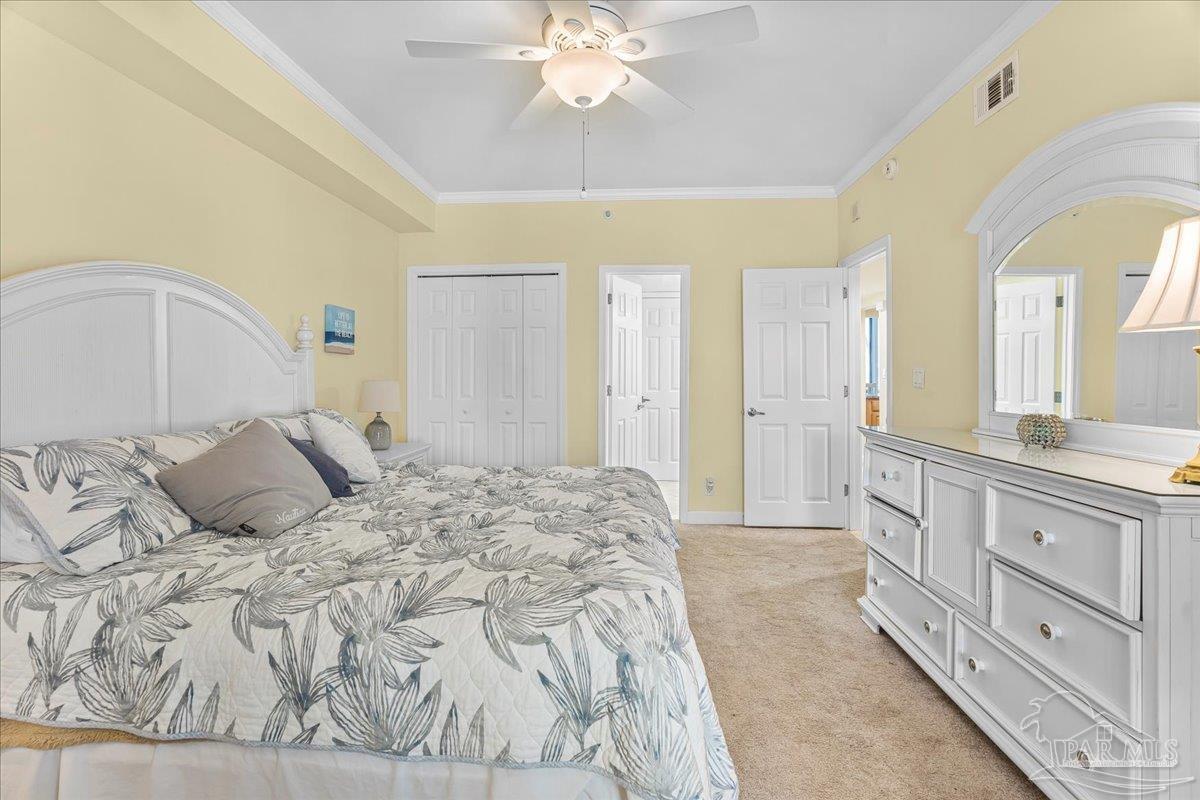 16284 Perdido Key Drive, Unit 112 Perdido Key, FL 32507 - Photo 26 of 37 a bedroom with a large bed and a chandelier