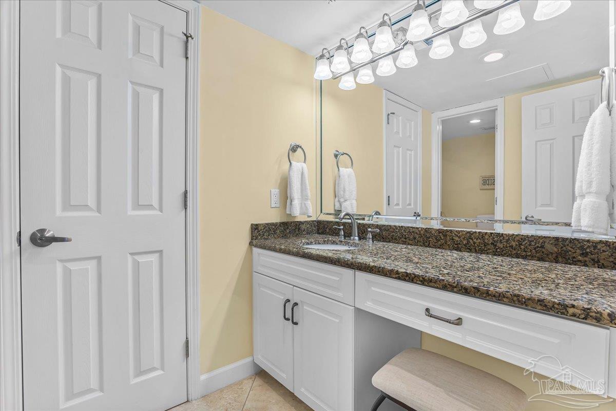 16284 Perdido Key Drive, Unit 112 Perdido Key, FL 32507 - Photo 27 of 37 a bathroom with a granite countertop sink and a mirror