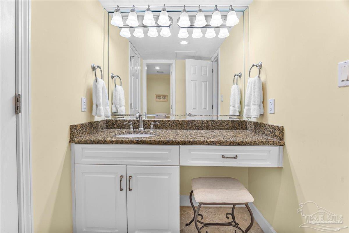 16284 Perdido Key Drive, Unit 112 Perdido Key, FL 32507 - Photo 29 of 37 a bathroom with a granite countertop sink and a mirror