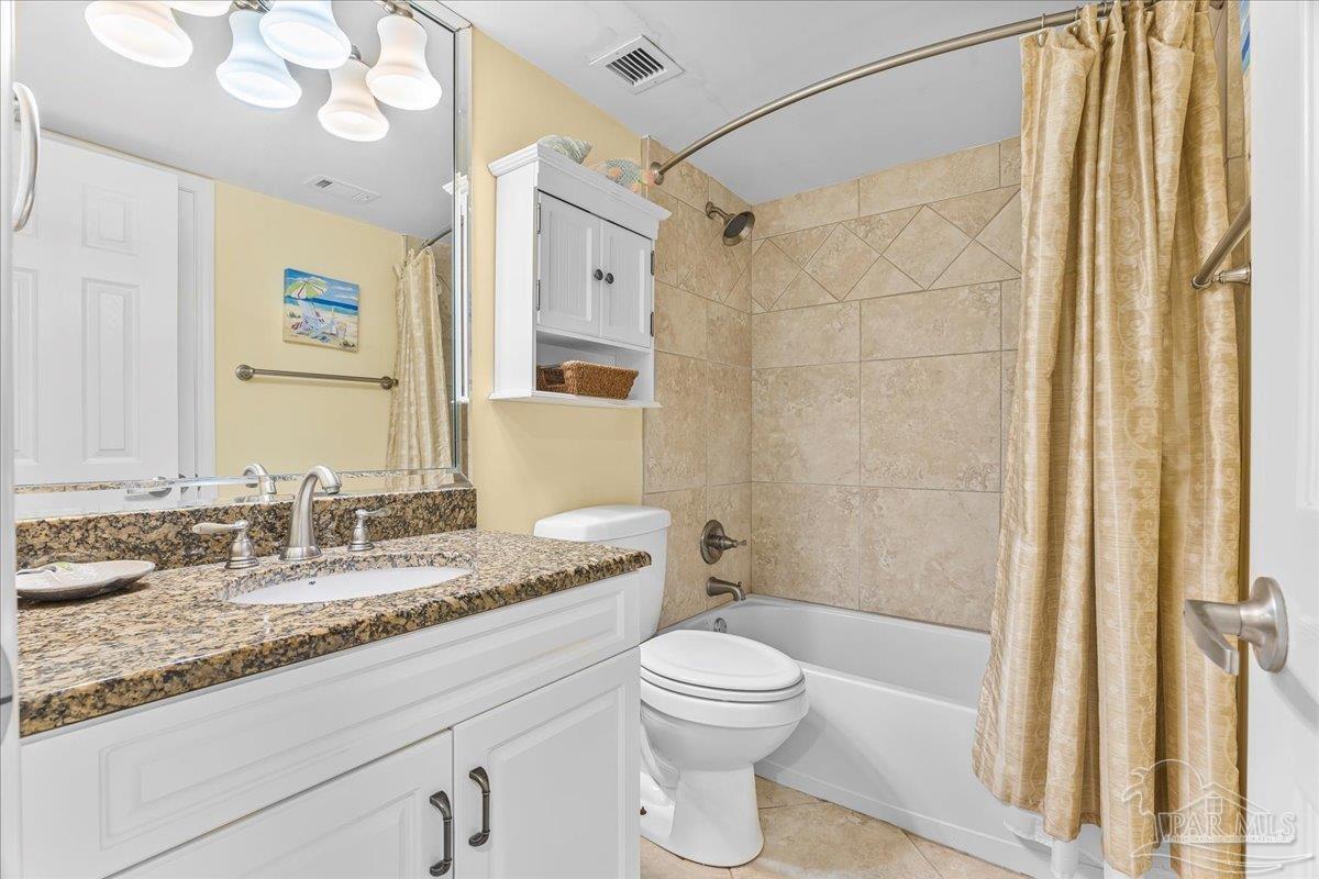 16284 Perdido Key Drive, Unit 112 Perdido Key, FL 32507 - Photo 30 of 37 a bathroom with a granite countertop sink toilet a mirror a vanity and shower