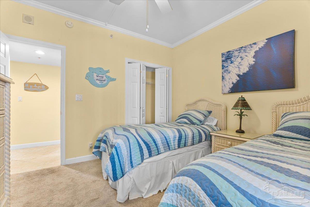 16284 Perdido Key Drive, Unit 112 Perdido Key, FL 32507 - Photo 32 of 37 a bedroom with two beds and painting on the wall