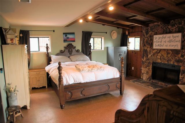 a bedroom with a bed and a mirror