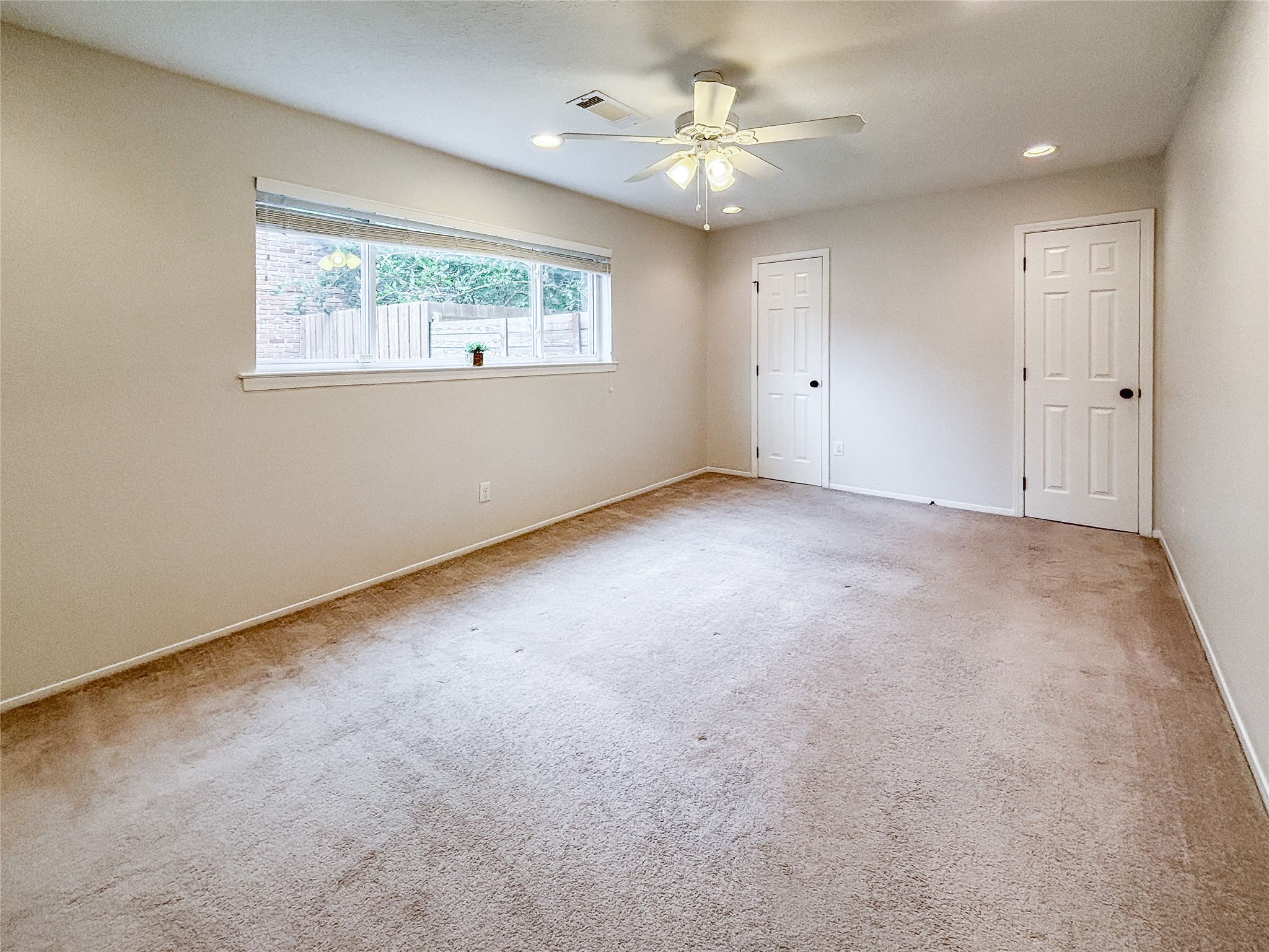3123 Lazy Spring Drive Houston, TX 77080 - Photo 13 of 24 an empty room with a ceiling fan and window