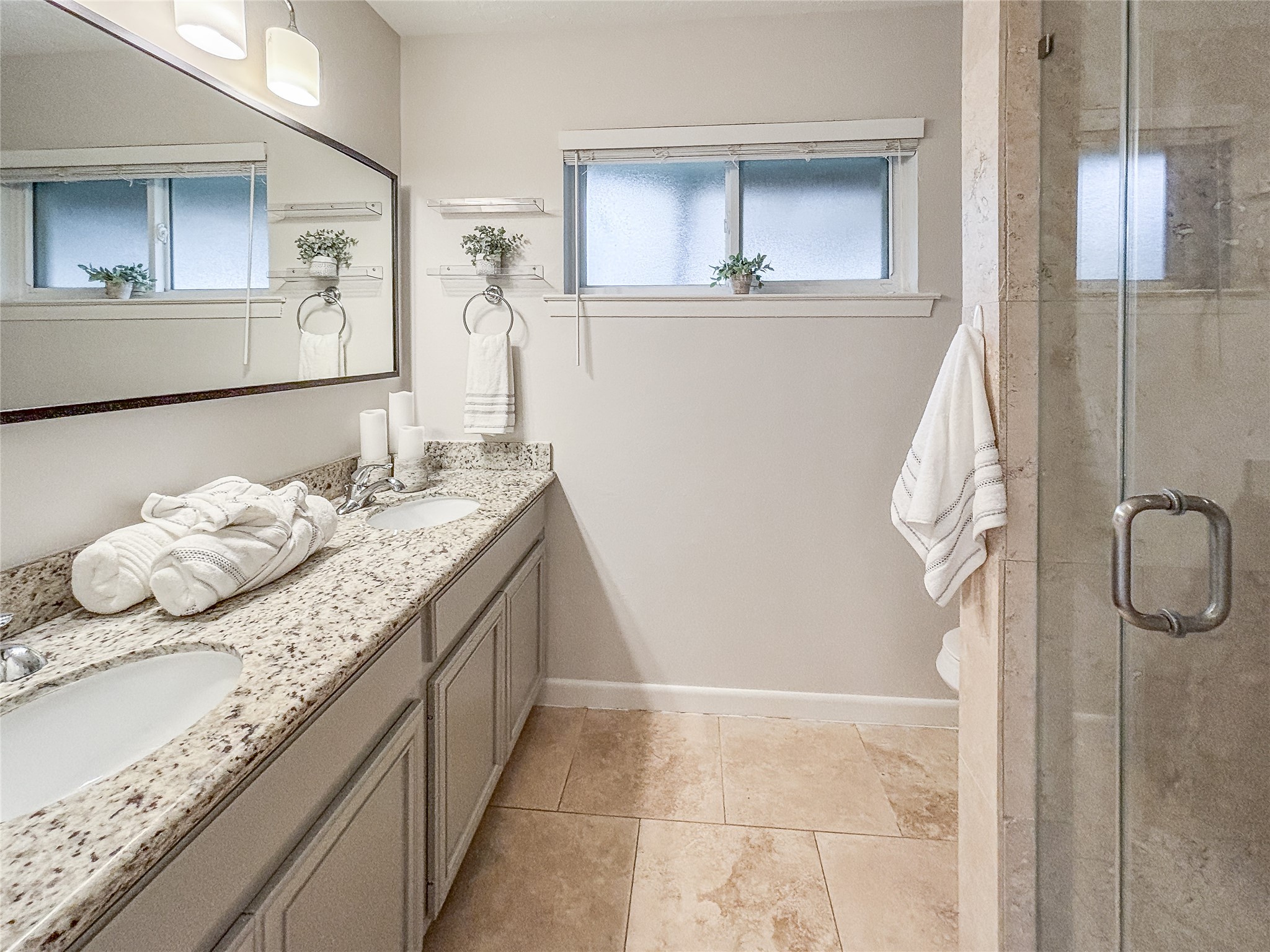 3123 Lazy Spring Drive Houston, TX 77080 - Photo 15 of 24 a bathroom with a granite countertop sink a mirror and a shower