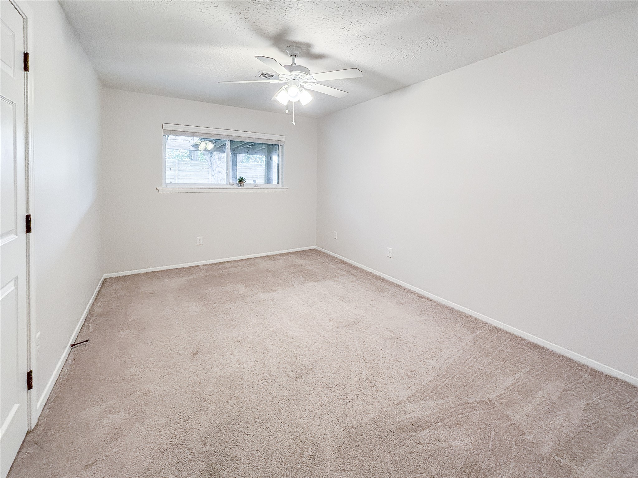 3123 Lazy Spring Drive Houston, TX 77080 - Photo 17 of 24 an empty room with windows and fan