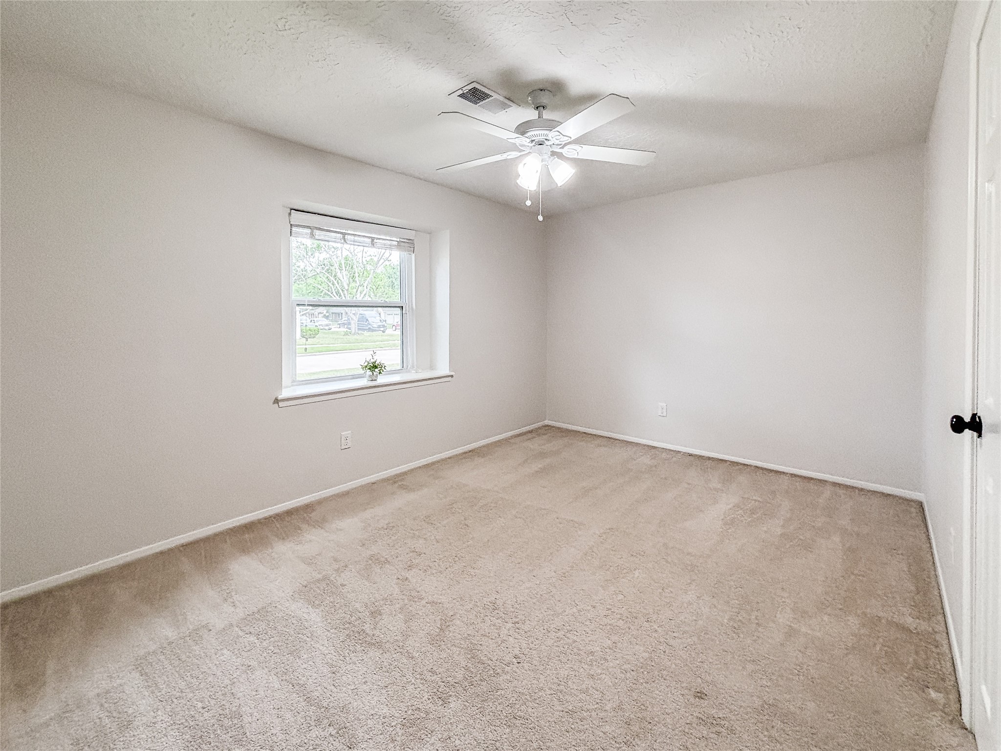 3123 Lazy Spring Drive Houston, TX 77080 - Photo 18 of 24 an empty room with a chandelier fan and windows