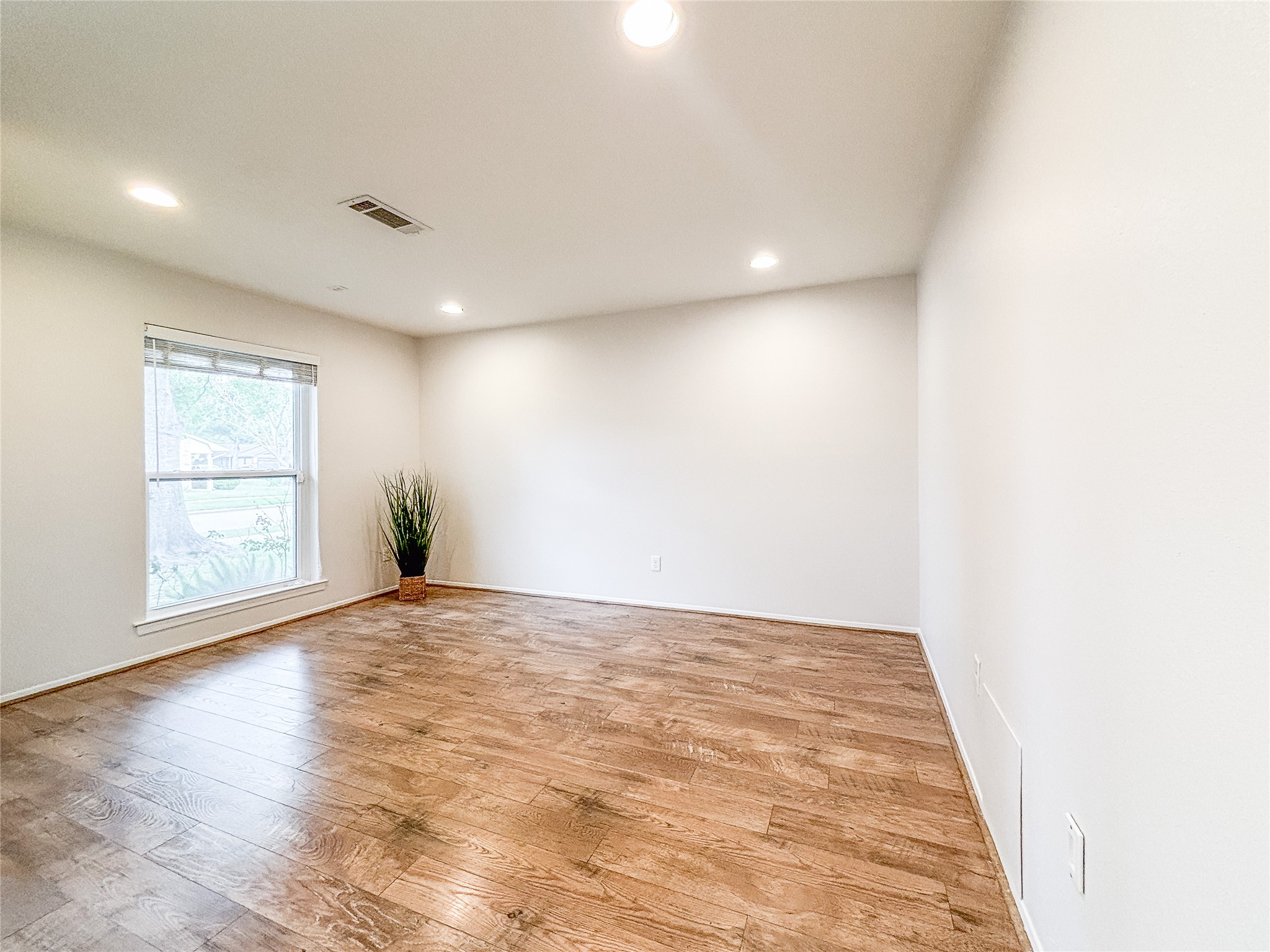 3123 Lazy Spring Drive Houston, TX 77080 - Photo 5 of 24 a view of an empty room with wooden floor and a window