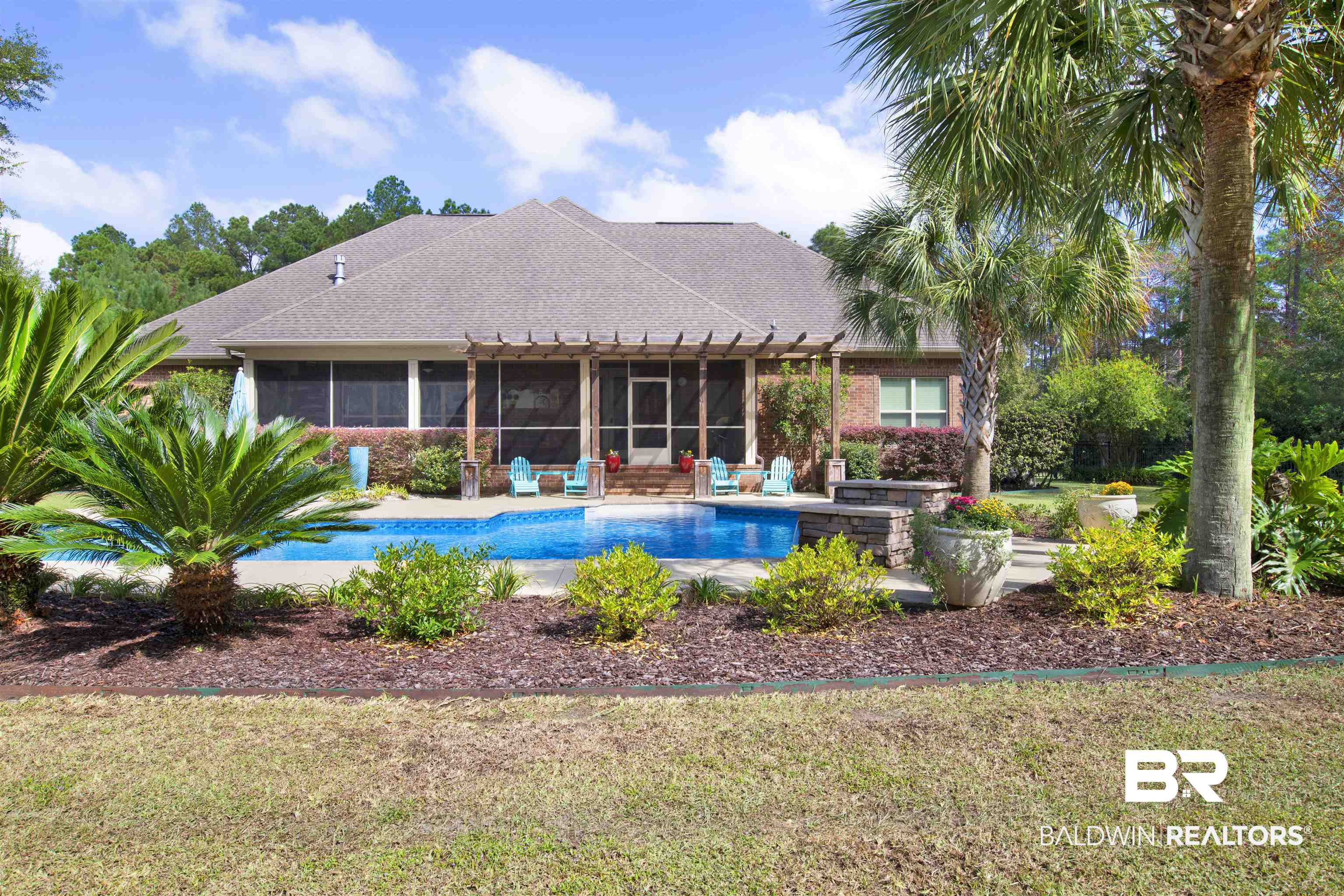 18360 Treasure Oaks Road Gulf Shores, AL 36542 - Photo 50 of 57 View of swimming pool with a sunroom, a yard, and a patio