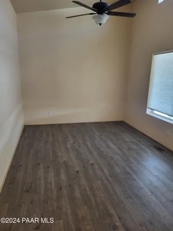 an empty room with wooden floor and closet