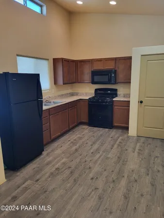 a kitchen with stainless steel appliances granite countertop a refrigerator and a stove