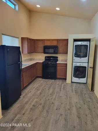 a kitchen with stainless steel appliances a refrigerator and a stove top oven