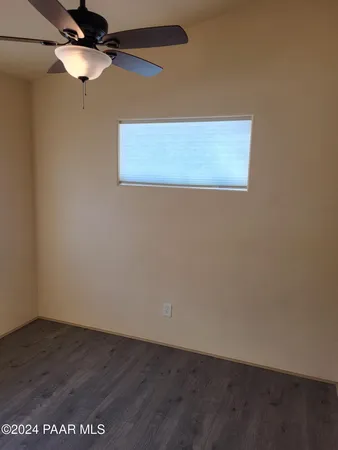an empty room with wooden floor and closet