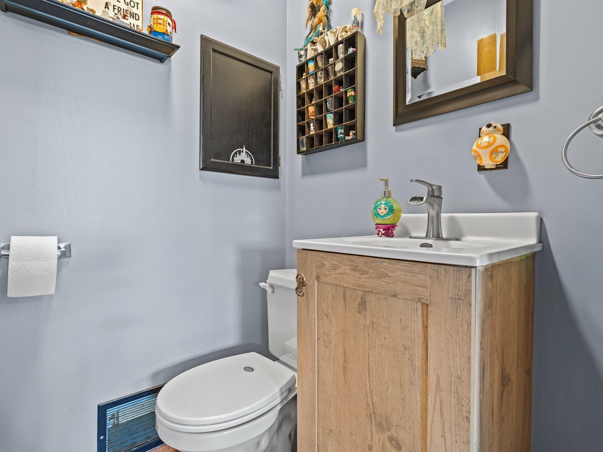614 West Elm Street Griffith, IN 46319 - Photo 14 of 16 a bathroom with a sink vanity mirror and toilet