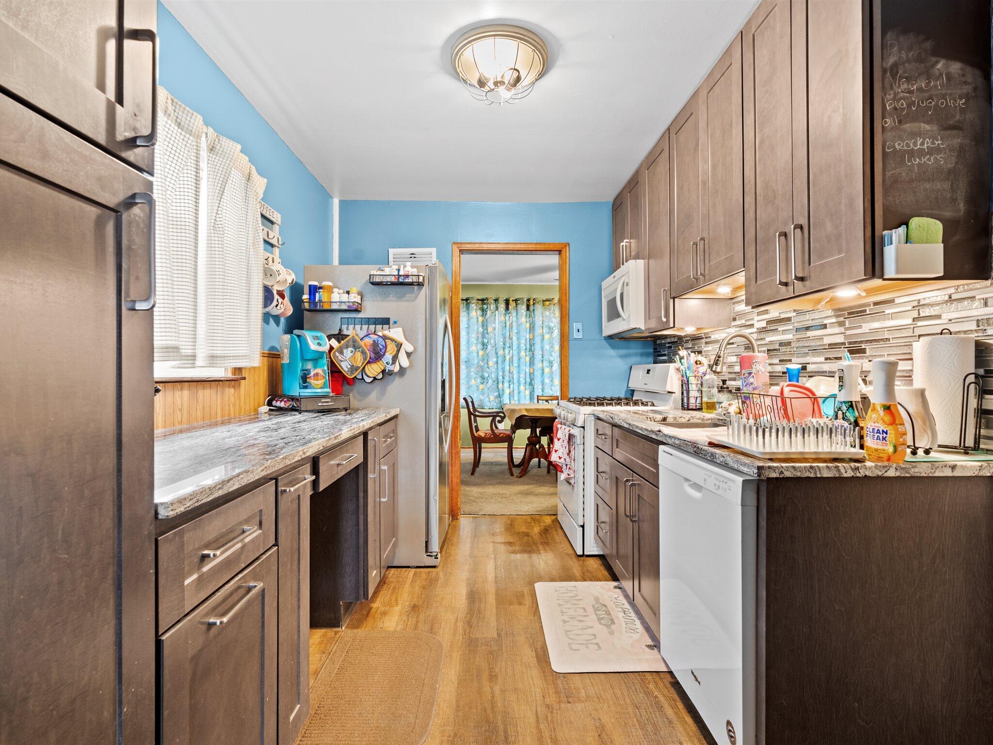 614 West Elm Street Griffith, IN 46319 - Photo 5 of 16 a kitchen with granite countertop a sink stove and cabinets