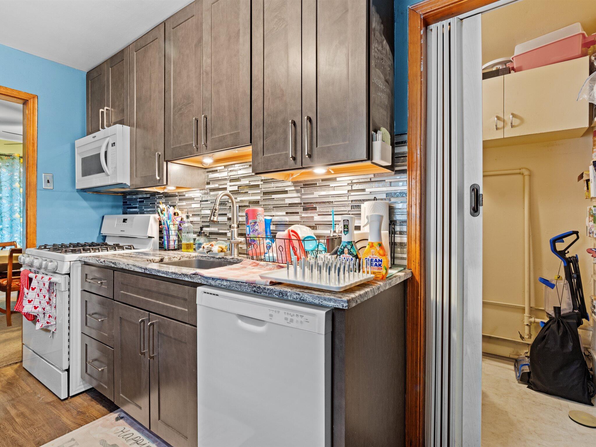 614 West Elm Street Griffith, IN 46319 - Photo 7 of 16 a utility room with stainless steel appliances granite countertop a sink and cabinets