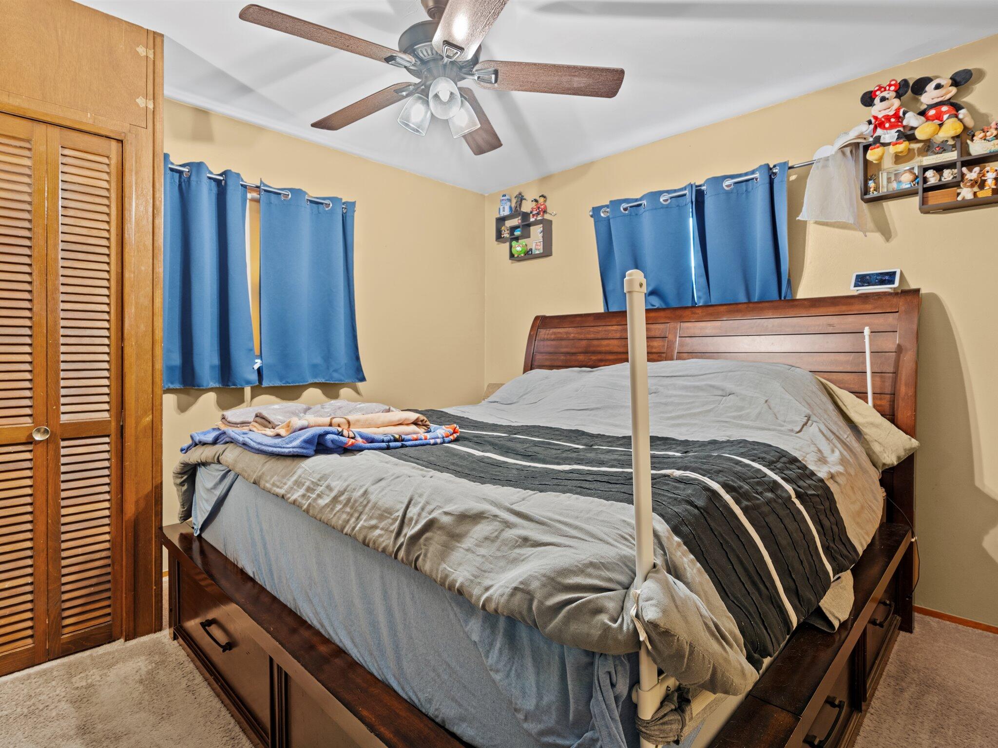 614 West Elm Street Griffith, IN 46319 - Photo 8 of 16 a bedroom with a bed and a chandelier