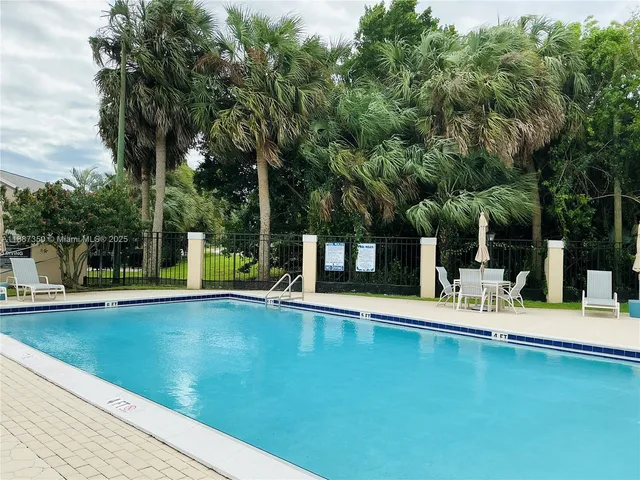 a view of a swimming pool with a table and chairs