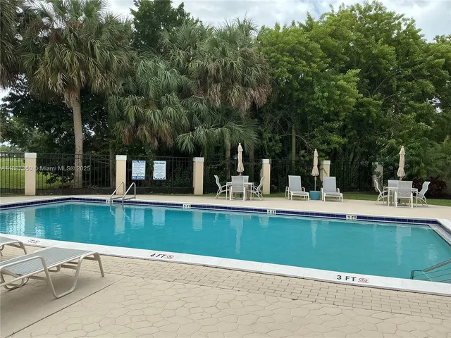 swimming pool view with a outdoor seating