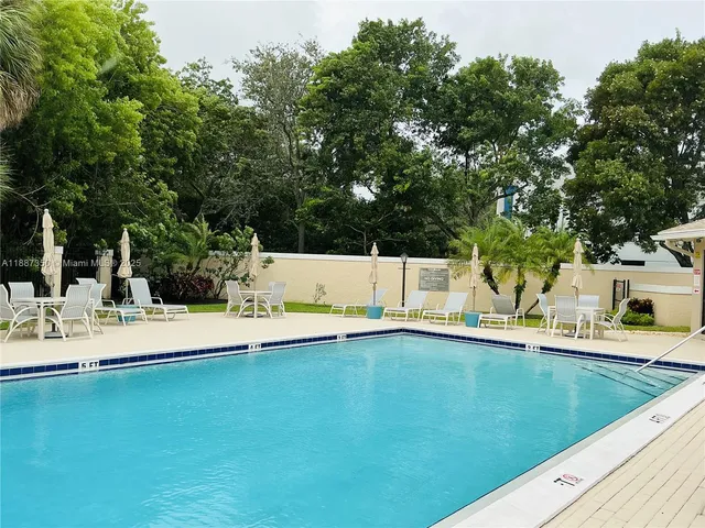 a view of an outdoor space with swimming pool and furniture
