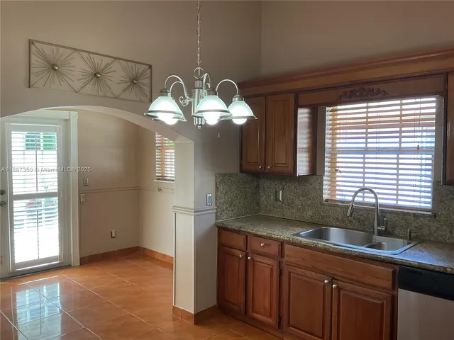 a kitchen with a sink and chandelier