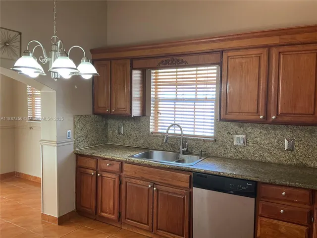a kitchen with a sink cabinets and window