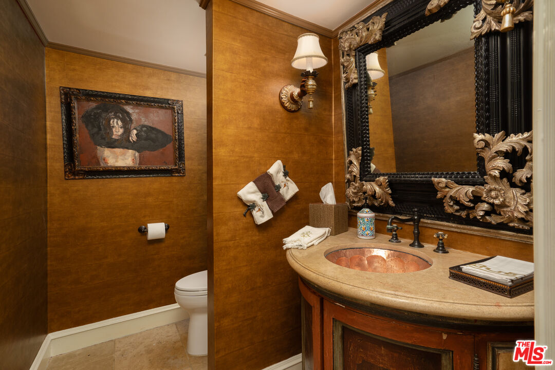 722 North Elm Drive Beverly Hills, CA 90210 - Photo 14 of 51 a bathroom with a sink a toilet and mirror