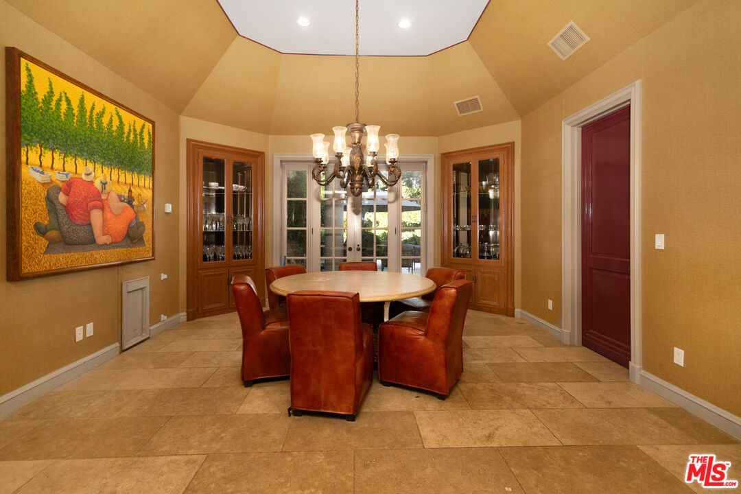 722 North Elm Drive Beverly Hills, CA 90210 - Photo 18 of 51 a dining room with furniture a chandelier and window