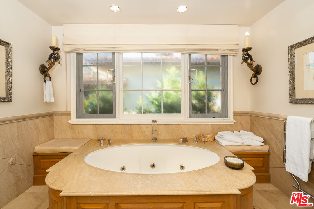 722 North Elm Drive Beverly Hills, CA 90210 - Photo 24 of 51 a bath tub sitting next to a window