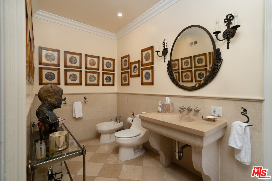 722 North Elm Drive Beverly Hills, CA 90210 - Photo 29 of 51 a bathroom with a toilet sink and mirror