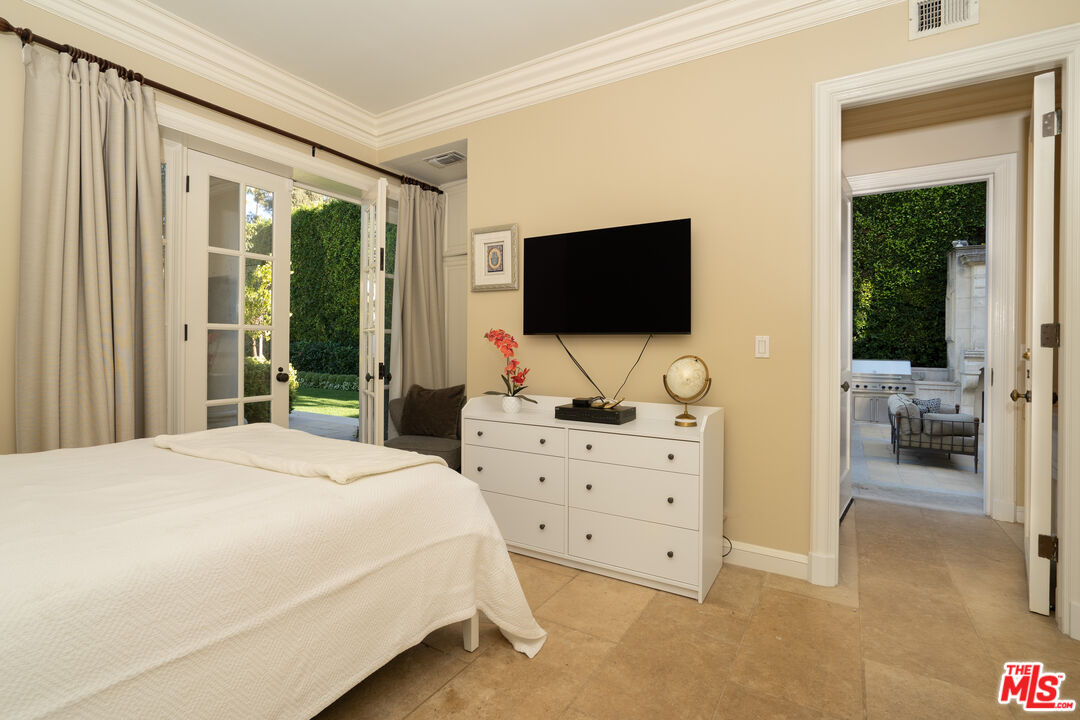 722 North Elm Drive Beverly Hills, CA 90210 - Photo 33 of 51 a bedroom with a bed and a flat screen tv