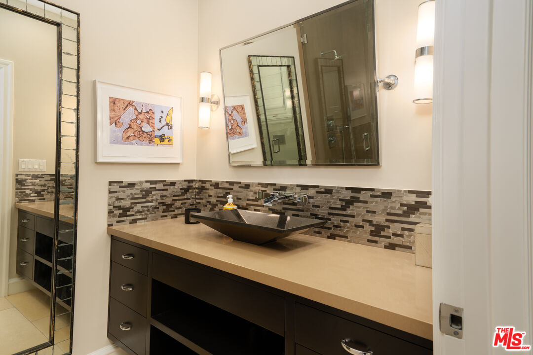 722 North Elm Drive Beverly Hills, CA 90210 - Photo 40 of 51 a bathroom with a sink and a mirror