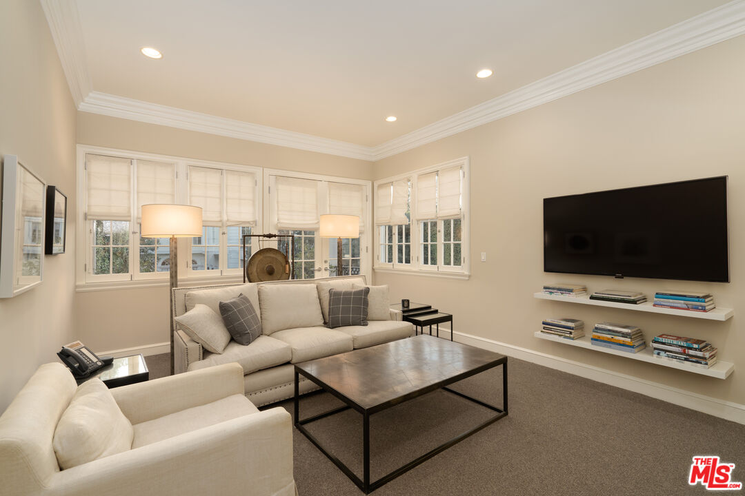 722 North Elm Drive Beverly Hills, CA 90210 - Photo 41 of 51 a living room with furniture and a flat screen tv