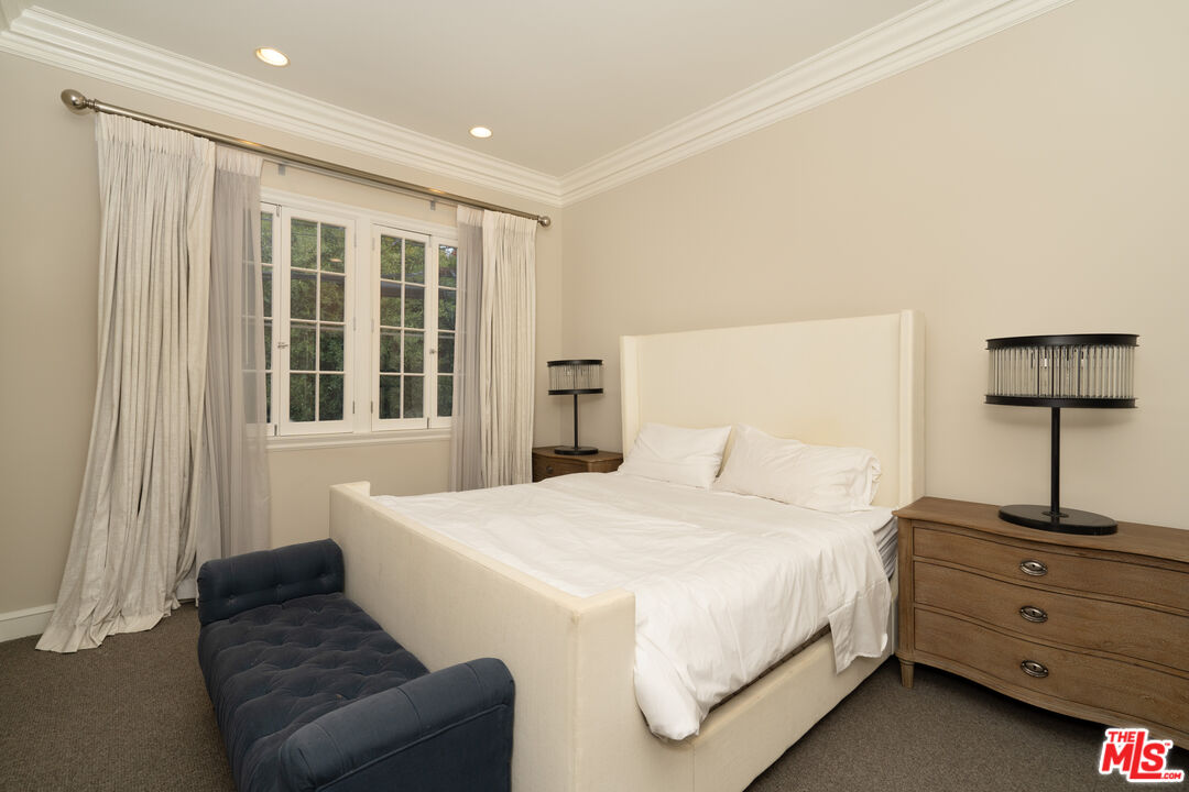 722 North Elm Drive Beverly Hills, CA 90210 - Photo 42 of 51 a bedroom with a bed and a window