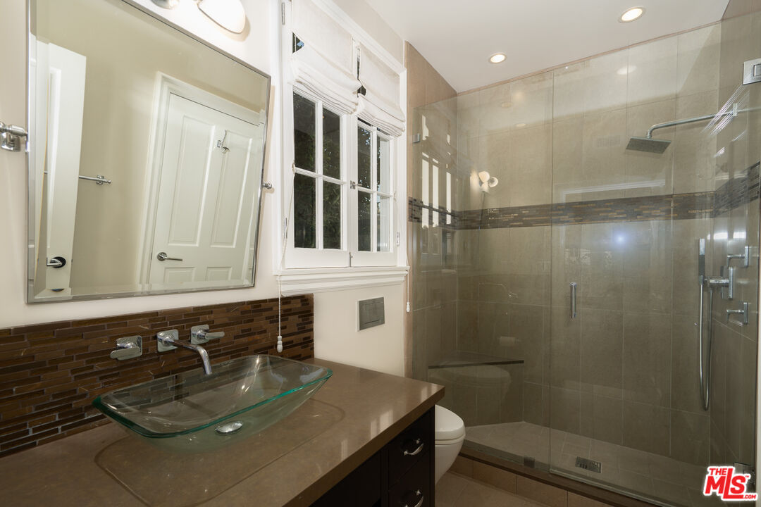 722 North Elm Drive Beverly Hills, CA 90210 - Photo 43 of 51 a bathroom with a sink a toilet and shower