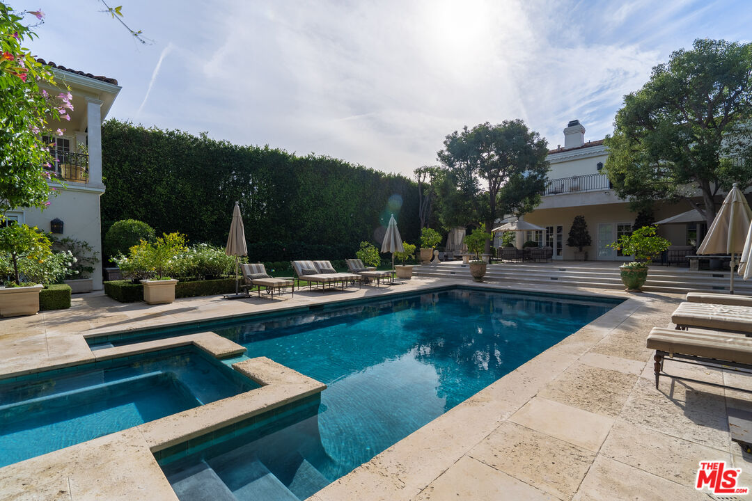 722 North Elm Drive Beverly Hills, CA 90210 - Photo 47 of 51 a view of a swimming pool with lounge chairs